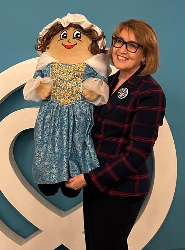State Treasurer Julie Ellsworth is pictured with one of the dolls she created to represent the country's founders. State Treasurer Julie Ellsworth is pictured with one of the dolls she created to represent the country's founders.