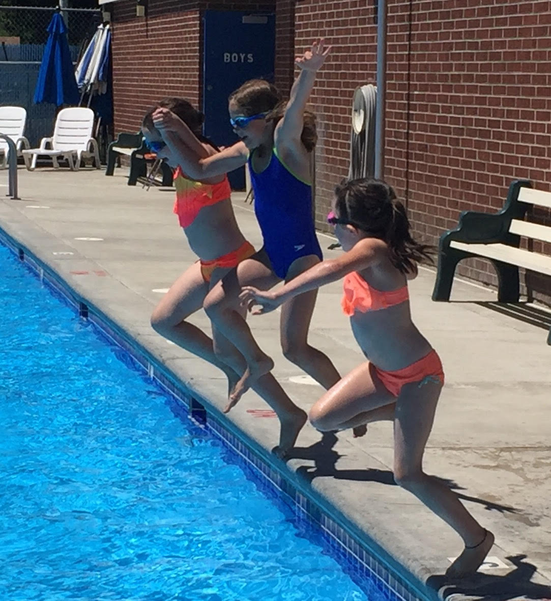 Three girls jump into the Nezperce pool.